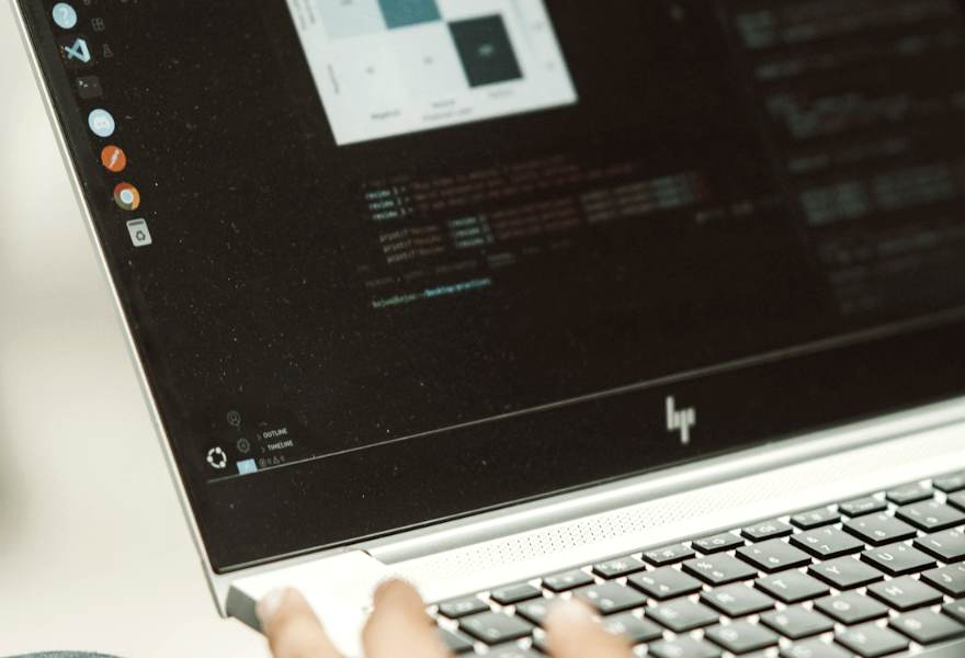 Hands typing on a laptop showing data analysis